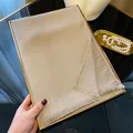 Elegant champagne gold silk scarf with fine glitter and fringe on a display tray - Champagne