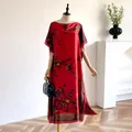 Elegant red silk-like maxi dress with plum blossom print and a wide boat neckline - Red