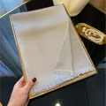 Silver grey tencel cotton scarf with shiny metallic thread and fringe on a golden tray - Gray