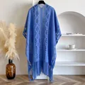 Close-up of blue hollow-out knit shawl featuring delicate lace patterns and long fringe tassels - Blue