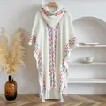 White knit hooded poncho with colorful stripes and long fringe in bohemian ethnic style - White
