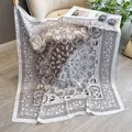 Brown and white paisley faux silk square scarf draped on a sofa with fashion accessories - 90sj-019 White / 90*90cm