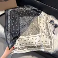 Retro black and white paisley silk scarf displayed on leather and plush background - 70fj-447-black And White / 70*70