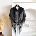 Elegant black lace triangular shawl with floral cutout patterns and long fringe tassels - Black
