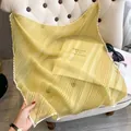 Elegant pale yellow pleated faux silk square scarf draped over a classic beige chair - Large Square / Yellow