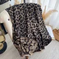 Classic brown leopard print thick shawl with fringe detail on a cream sofa - 185cmx65cm / Black