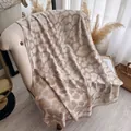 Elegant beige leopard knit poncho shawl with soft fringe detail on an armchair - 185cmx65cm / White