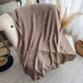 Mocha brown scarf with golden heart prints and fringe edges on a cream sofa - Red Brown