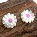 Macro view of shell flower earrings with white petals and purple centers on wood - Violet Stamen