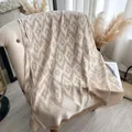 Beige and brown geometric pashmina shawl with long tassels draped on a chair - 185x65 / White