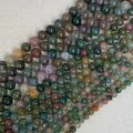 Close-up of polished natural India Agate beads with mineral textures for DIY jewelry - Colorful Jade