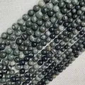 Detailed close-up of natural green stone beads in various sizes for DIY jewelry - Green Wood Grain