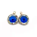 Detailed macro of two blue faceted evil eye stone pendants with gold metal frames - Size 3 / 13mm 1.2g/piece (20 Pieces/pack)