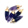 Close-up of five faceted amethyst bullet pendants with golden caps for DIY jewelry - Purple Crystal
