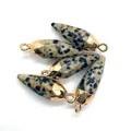 Close-up of five bullet-shaped Dalmatian Jasper pendants with golden metal caps - Dalmatian Jasper