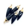 Macro view of five faceted black stone bullet pendants with gold metallic plating - Black Agate