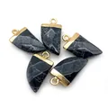 Detail view of five marble stone pendants with gold bails in a horn shape for jewelry DIY - Black Line Howlite