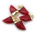 Five pieces of faceted red semi-precious stone dagger pendants with golden metal caps - Carnelian