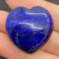 Polished heart-shaped Lapis Lazuli stone bead with golden pyrite flecks held in hand - 30x30mm, 14mm Thickness / Lapis Lazuli