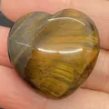 Polished tiger eye heart stone with golden brown chatoyancy held in a palm for scale - 30x30mm, 14mm Thickness / Tiger's Eye