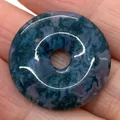 Natural green moss agate stone donut pendant with unique mineral texture held in hand - Moss Agate (No. 3)