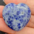 Polished heart-shaped blue sodalite stone bead held by hand for DIY jewelry making - 30x30mm, 14mm Thickness / Sodalite