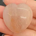 Polished heart-shaped rose quartz natural stone bead held in hand for jewelry making - 30x30mm, 14mm Thickness / Peach Stone (No. 35)