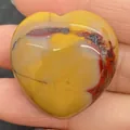 Polished Mookaite Jasper heart stone in vibrant yellow and red, held in hand for scale - 30x30mm, 14mm Thickness / Yellow Jasper