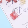 Detailed view of pink flower stone pendant with silver bail on a decorative background - Watermelon Quartz