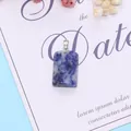 Macro detail of a rectangular blue sodalite stone pendant with silver metal bail - 16x24mm / Blue Spot Stone