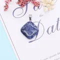 Close-up of a polished square sodalite stone pendant with natural blue marble patterns - 24x28mm / Blue Sodalite