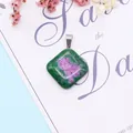 Detailed macro view of Ruby in Zoisite rhombus pendant on elegant script background - 24x28mm / Ruby Zoisite