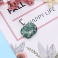 Apple-shaped Ruby in Zoisite stone pendant with silver clasp on a floral background - Ruby Zoisite