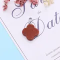 Quadrifoil pendant in reddish-brown goldstone with shimmering flecks and silver bail - Gold Sandstone