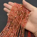 Faceted natural pink tourmaline beads on strings held by hand for jewelry making - Two-Tone Stone / 6mm