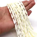 Macro shot of cream white teardrop shell beads for DIY jewelry making held by hand - 4x7mm / White
