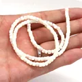 Macro shot of square white mother of pearl shell beads on a string for jewelry making - Flat Square Beads / 3x4mm / White