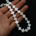 Macro detail of natural white mother-of-pearl clover flower beads for jewelry making - 6mm / White