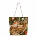 Detail view of canvas tote bag with cat and leaf print and white rope handles - Hammock Resting Tabby Cat (ms2862)