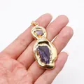 Detailed view of hand holding a raw purple crystal pendant with gold electroplated edge - No. 1 Single Color 50 Pieces/pack / 25-60mm,16-18g
