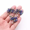 Close-up of handmade silver wire wrapped heart shaped life tree pendant with blue stones - Lapis Lazuli