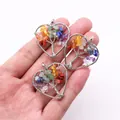 Macro detail of handmade wire-wrapped heart pendants featuring colorful Seven Chakra stones - Colorful