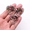 Silver tree of life heart pendants with colorful tourmaline gemstones in hand - Tourmaline