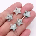 Macro detail of faceted star-shaped natural stone beads with pre-drilled holes on fingertips - Azurite