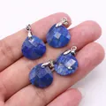 Macro detail of four faceted lapis lazuli teardrop pendants held in hand with silver bails - 16x17mm / Lapis Lazuli
