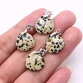 Macro shot of four faceted teardrop Dalmatian Jasper pendants held in palm for DIY jewelry - 16x17mm / Dalmatian Jasper