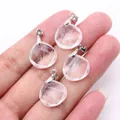 Detail view showing four faceted teardrop pendants held in hand for size and scale - 16x17mm / Transparent Crystal