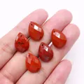 Macro shot of five faceted red jasper water drop pendants showing natural stone textures - 13x18mm / Rainbow Stone