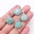 Hand holding four faceted amazonite teardrop pendants with silver metal clasps - 16x17mm / Amazonite