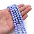 Blue lace agate beads held in hand showing natural white patterns and translucent texture - 4mm / Light Blue (Blue Lace Agate Pattern)